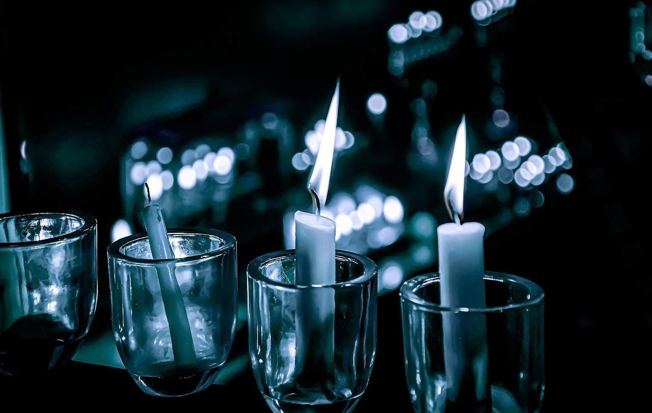 Image of  three small glasses with a lite candle inside