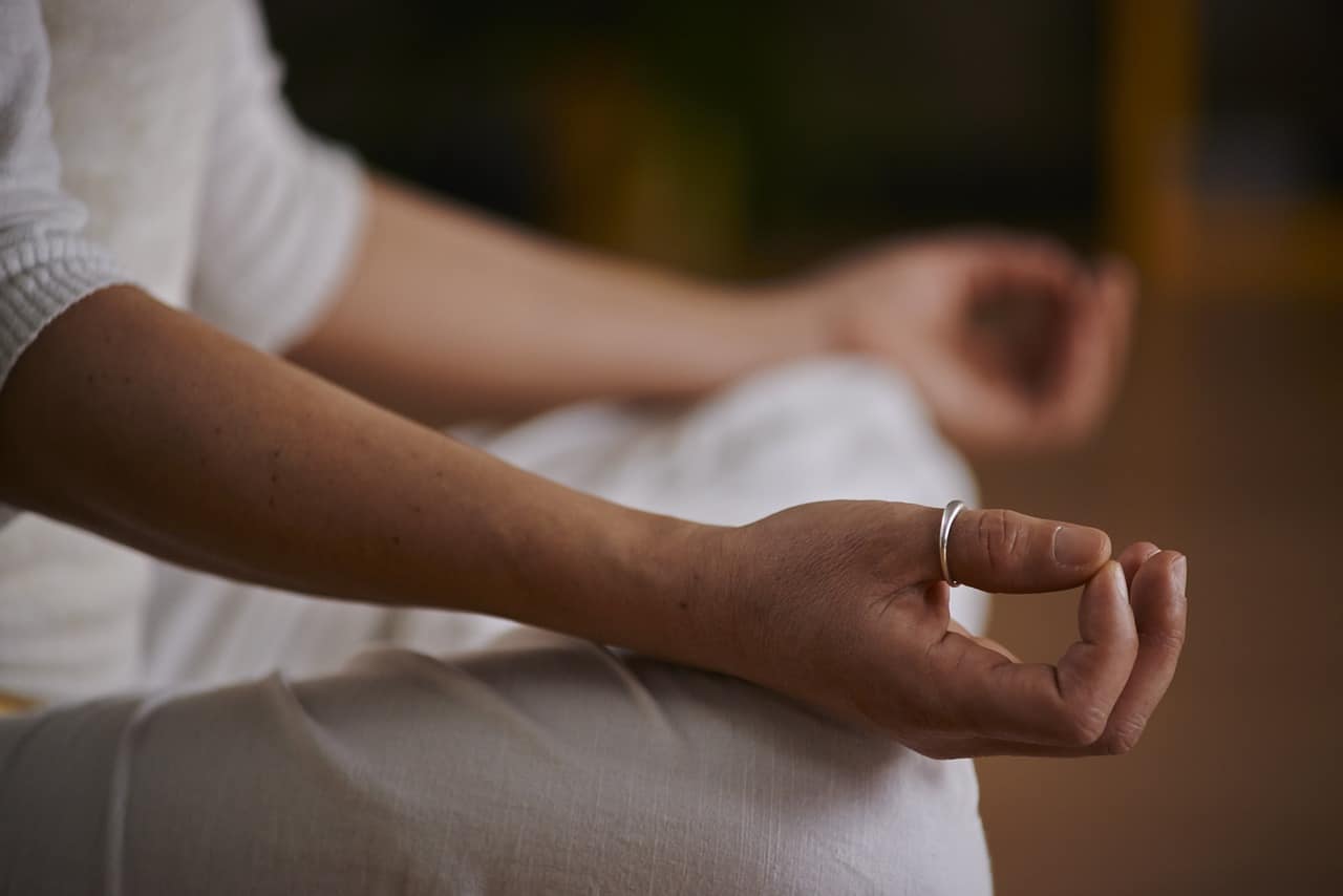 Close up of a persons meditation hands in a mudra position