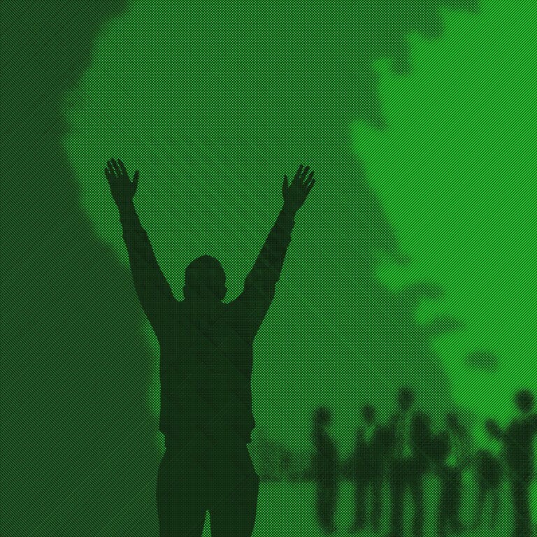 Image of a silhouette man holding his arms up high and a green misty background
